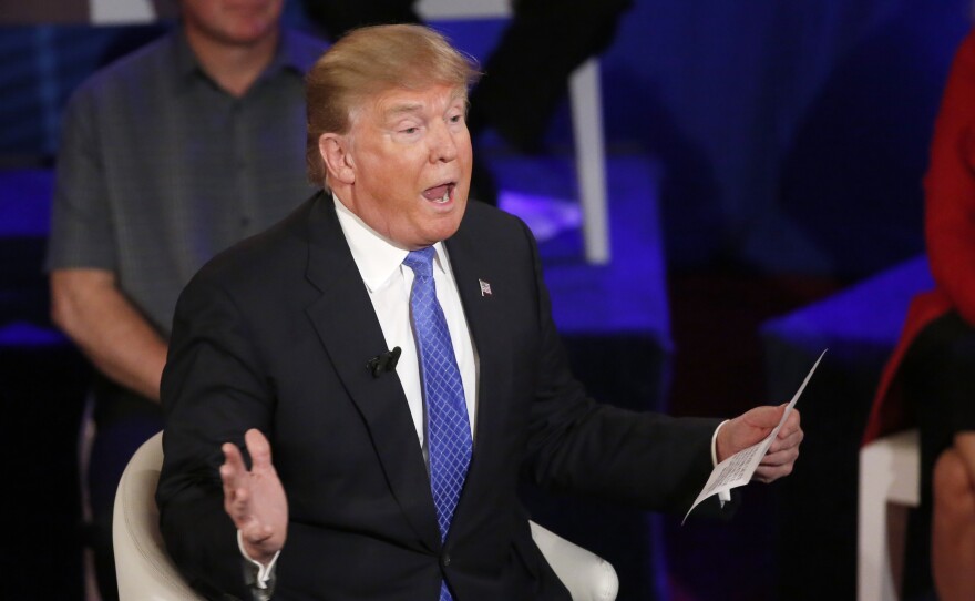 Republican presidential candidate Donald Trump talks about a statement from a Breitbart News reporter during a CNN town hall Tuesday, in Milwaukee.