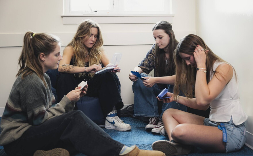 Two teens look at different kinds of birth control with an intern and staff member of Bridgercare in June 2025. Bridgercare, a nonprofit based in Bozeman, Mont., had its federal grant abruptly canceled.