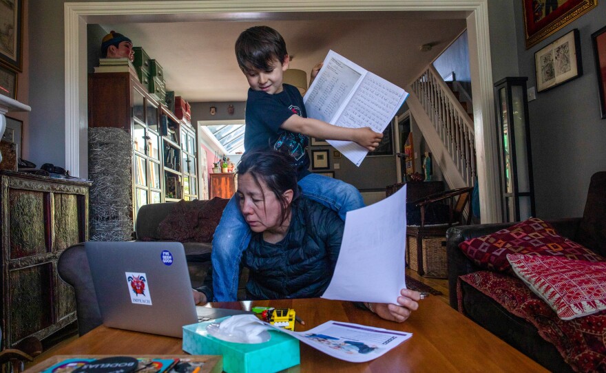 Joe climbs onto his mother's shoulders during a home lesson.