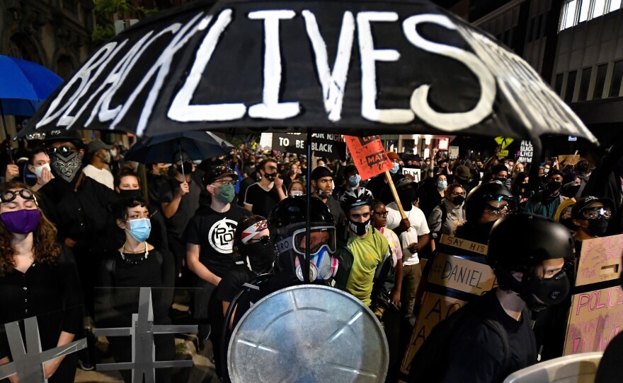 Demonstrators march through the streets in Rochester, N.Y., Friday, Sept. 4, protesting the death of Daniel Prude. Prude apparently stopped breathing as police in Rochester were restraining him in March 2020 and died when he was taken off life support a week later.