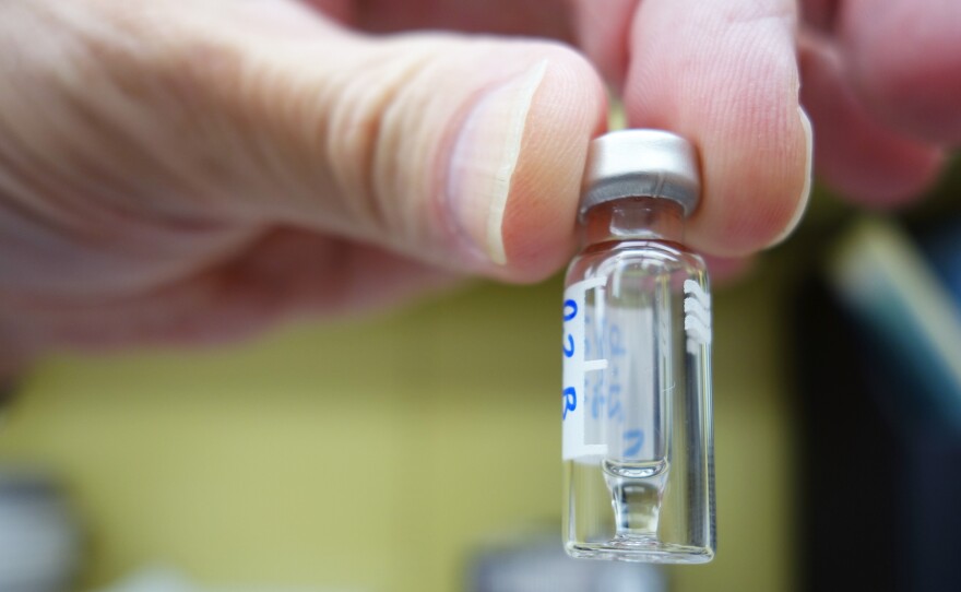 Bob Topmiller, chief of toxicology at the Hamilton County Coroner's Office, holds a small vial containing carfentanil extracted from a sample of blood.