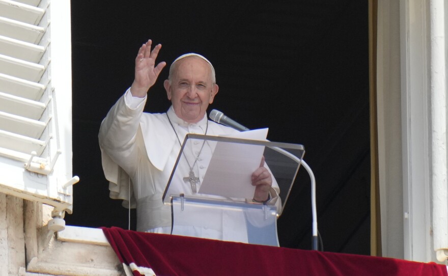 Pope Francis waves to the crowd from the window of his studio overlooking St.Peter's Square, at the Vatican. In a brief announcement Sunday afternoon the Vatican said Pope Francis has gone to a Rome hospital for scheduled surgery.