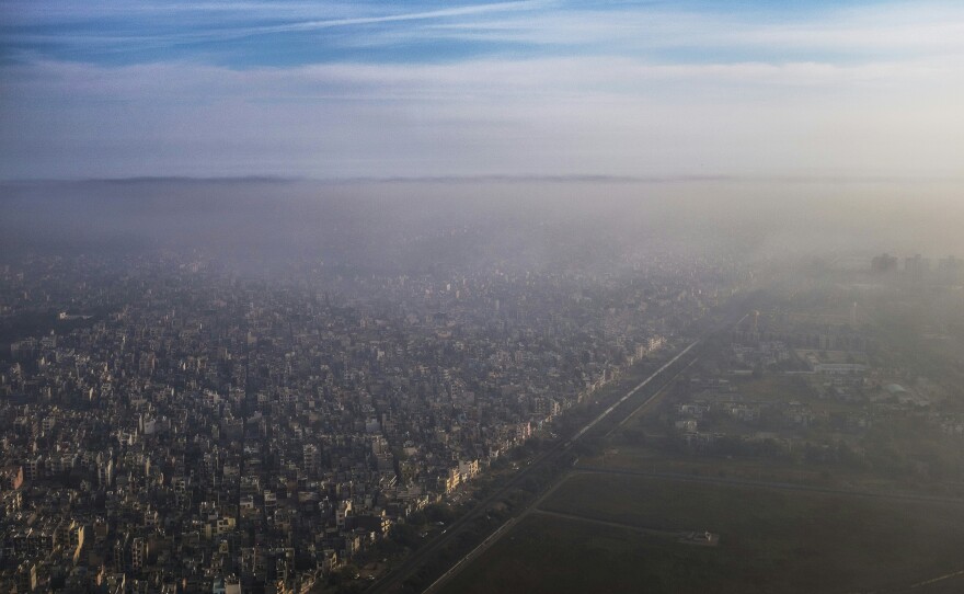 A blanket of smog extends over a densely populated neighborhood adjacent to the main airport in New Delhi in March. New Delhi's air pollution is among the world's worst.