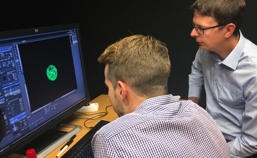Fredrik Lanner (right) of the Karolinska Institute in Stockholm and his student Alvaro Plaza Reyes examine a magnified image of an human embryo that they used to attempt to create genetically modified healthy human embryos.