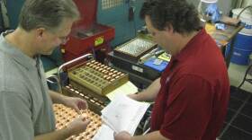 Brothers Michael (left) and Timothy Martens inspect copper machine parts on the factory floor of M&H Engineering. The company has hired back some workers who were laid off during the recession.