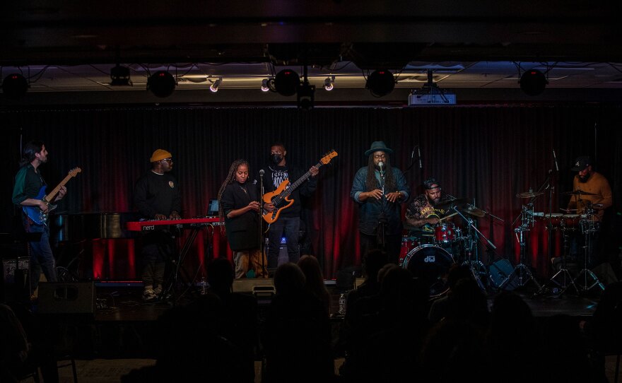 The Lyrical Groove perform on stage with Brisa Lauren at center-left and Kendrick Dial at center-right, shown in an undated photo.