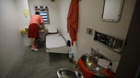 In this photo taken on Monday, Dec. 16, 2019, an inmate looks out a window in his solitary confinement cell at the Main Jail in San Jose, Calif. 