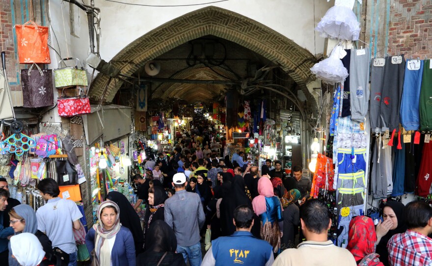 Iranians shop at the main bazaar in the capital, Tehran, on Sept. 16. Many Iranians have high expectations that their economic conditions will improve following the nuclear deal, which will lift some of the toughest sanctions against the country. But some analysts think the economic boost will be limited at best.