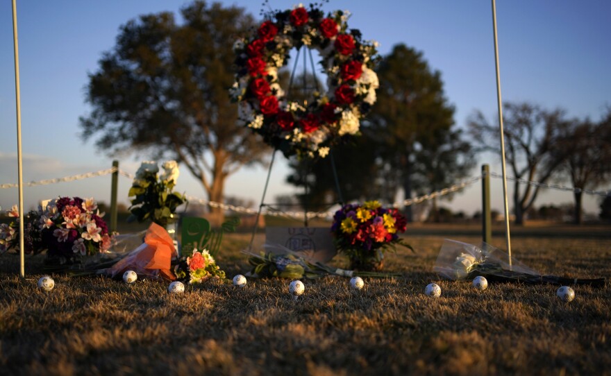 Golf balls adorn a makeshift memorial at the Rockwind Community Links on Wednesday in Hobbs, N.M. The memorial was for student golfers and the coach of University of the Southwest killed in a crash in Texas.