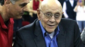 Jerry Tarkanian is escorted by his son, Danny, during halftime ceremonies honoring the former basketball coach at Fresno State University, March 1, 2014. 