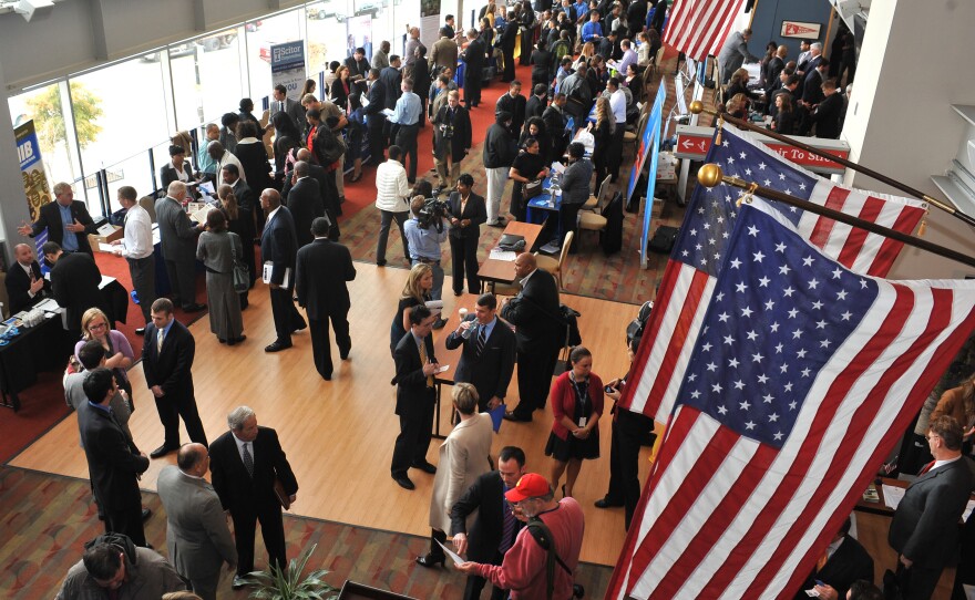 Hundreds of veterans and military spouses meet with prospective employers at the Hiring Our Heroes job fair at Nationals Park in Washington, D.C., in December. Veterans say they're still having trouble finding jobs and getting other types of assistance.