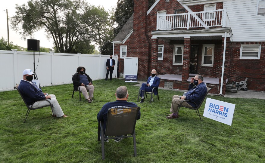 Democratic presidential nominee Joe Biden talks with members of the United Steelworkers union in a supporter's backyard last week in Detroit.