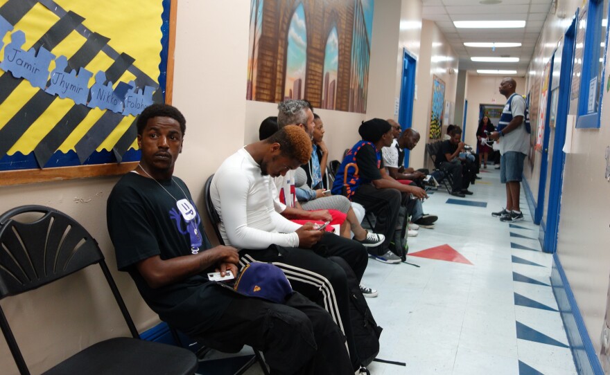 Clients hoping to get old warrants cleared wait in line to see a public defender in Brooklyn on Saturday. Their cases were heard in a makeshift courtroom in a church basement.