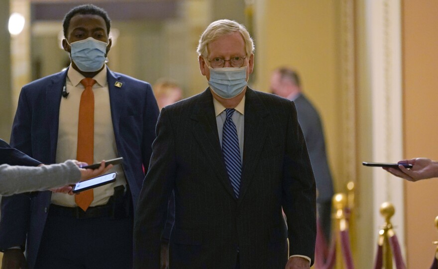 In this Dec. 15, 2020, photo, Senate Majority Leader Mitch McConnell of Ky., walks past reporters on Capitol Hill in Washington.