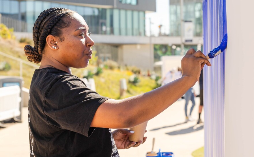 A participant is shown painting in Jeppe Hein's "Breathe With Me" project, installed at the University of San Diego on Oct. 24, 2024.