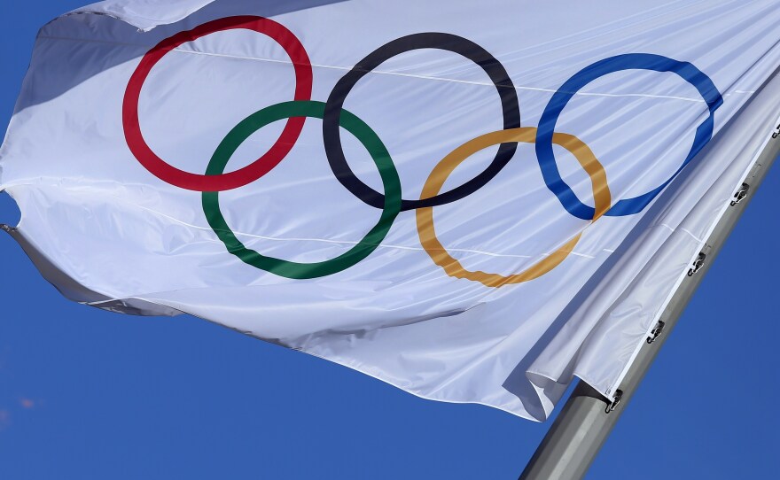 The Olympic flag flutters near the Cauldron at the Olympic Park during the 2014 Sochi Winter Olympics.