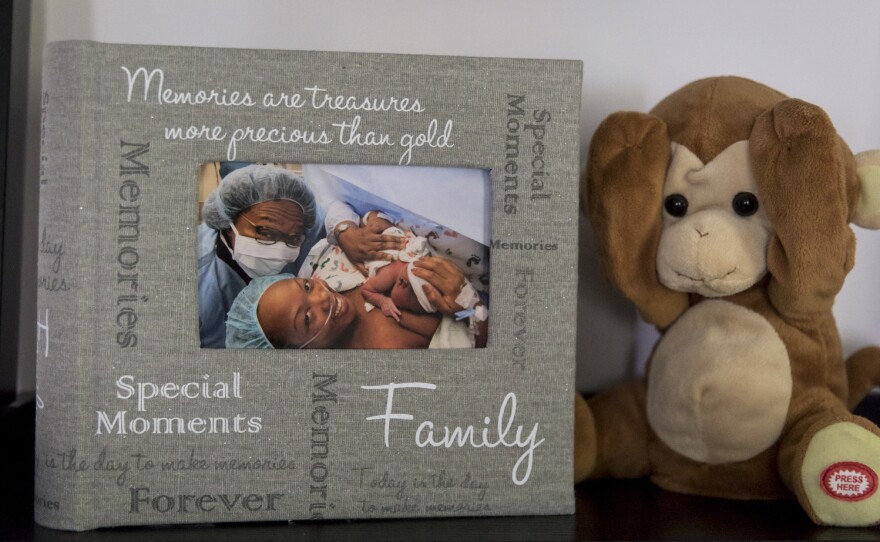 A photograph of Shalon with newborn daughter Soleil and mother Wanda is displayed on a shelf in Shalon's home next to the stuffed monkey that was given to Soleil in the hospital after she was born.