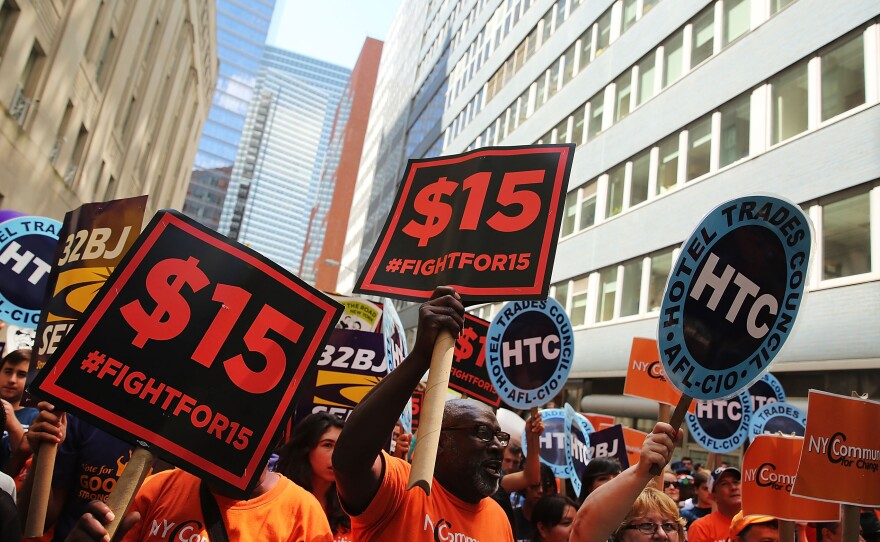 Labor leaders, workers and activists attend a rally for a $15 minimum hourly wage Wednesday in New York City. A panel appointed by Gov.  Andrew Cuomo recommended the increase.
