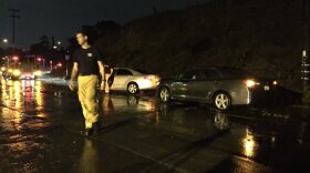 Fire crews work to free two cars stuck because of rising water between Federal Boulevard and San Miguel Avenue in Lemon Grove, Nov. 3, 2015.