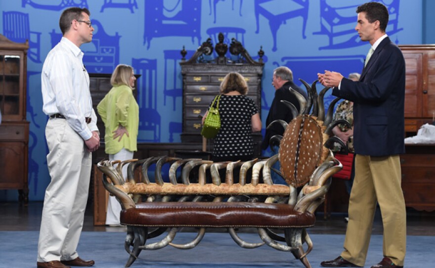 Andrew Brunk (right) appraises a cow horn settee, ca. 1990 in Charleston, W.Va.