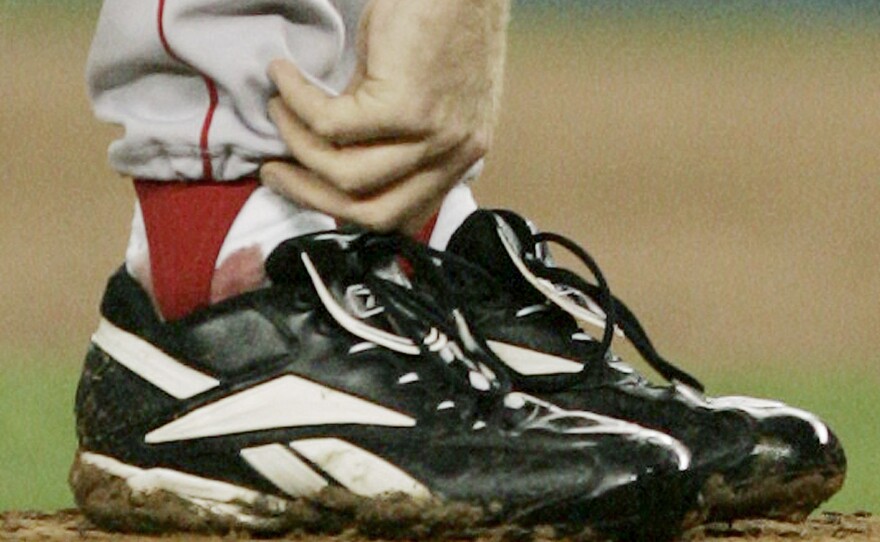 Schilling tends to his right ankle during Game 6 of the American League Championship Series against the New York Yankees in 2004.