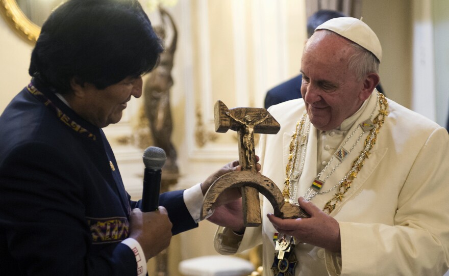 Bolivian President Evo Morales presents Pope Francis with a crucifix carved into a wooden hammer and sickle in La Paz, Bolivia, on Wednesday.