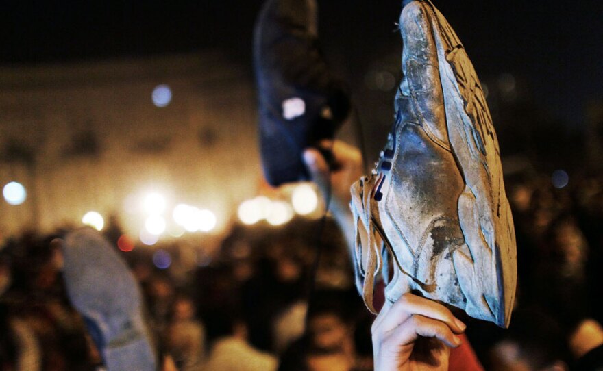 Protesters show the soles of their shoes, a grave insult in the Muslim world, after Egyptian President Hosni Mubarek announced on state television Tuesday that he would not run for another term in office.