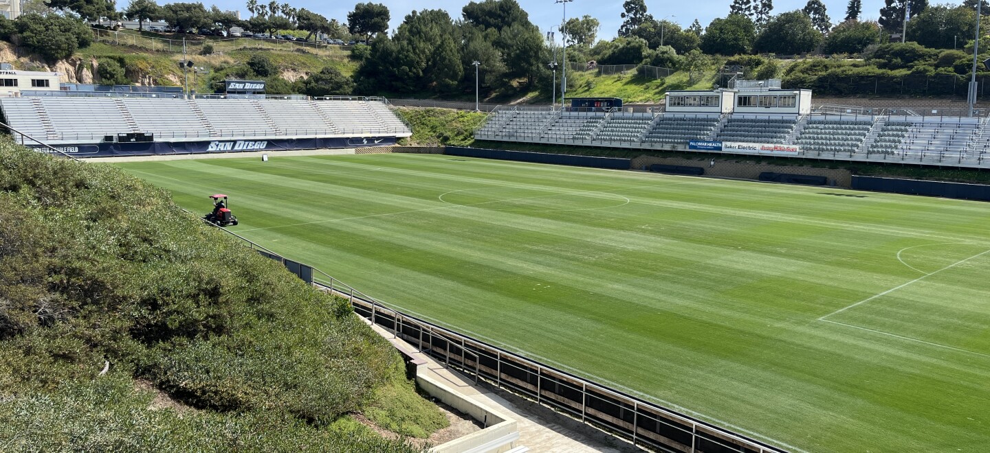 A landscaper trims the grassy field in a lawn mower at University of San Diego's Torero Stadium, March 16, 2026.