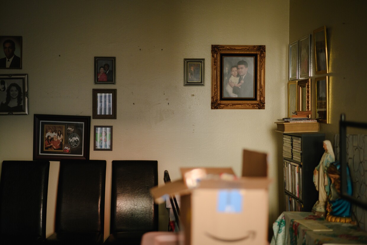 Family photographs rest on the wall of Sherman Qualls' home at The Swell apartments, formerly Sussex Gardens, in Imperial Beach, California on November 18, 2024. Qualls, a retired bus driver, has lived in the building for 18 years and has already begun to pack up his belongings to prepare for a potential eviction.