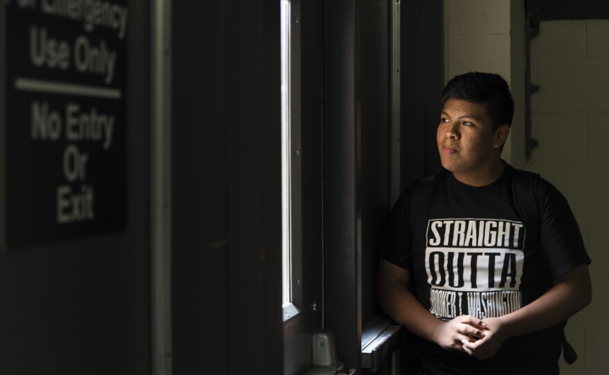 Jose waits for his friends under the stairs at the end of the school day.