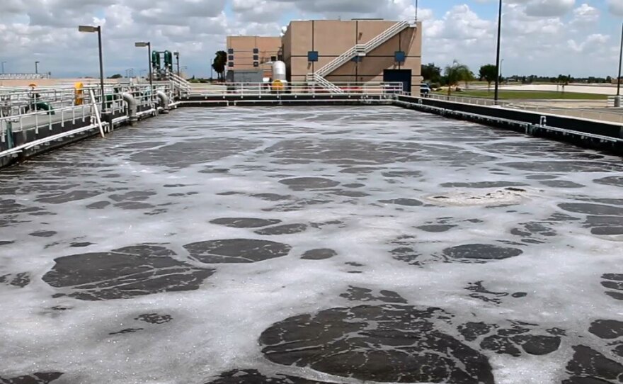 In the aeration basins, microorganisms break down organic material. This is part of the secondary treatment process.