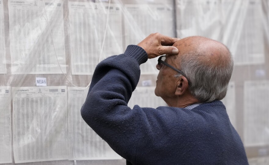 A man looks for his polling post during presidential elections in Bogota, Colombia, Sunday, May 29, 2022.