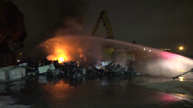 A fire burns at a recycling yard in Barrio Logan, July 23, 2015.