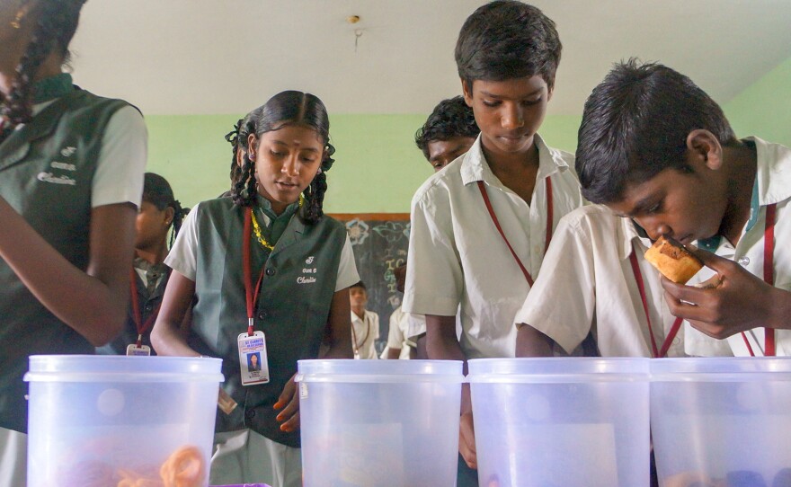 Children select a snack at St Claret's school in the southern Indian village of Karumathur. And then it's up to them whether to do the right thing and pay up.