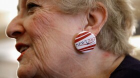 Judy Youngblood of Jacksonville, Fla., appears at a rally at the Hyatt Regency Jacksonville Riverfront hotel Monday, wearing earrings she made from campaign buttons supporting Newt Gingrich.