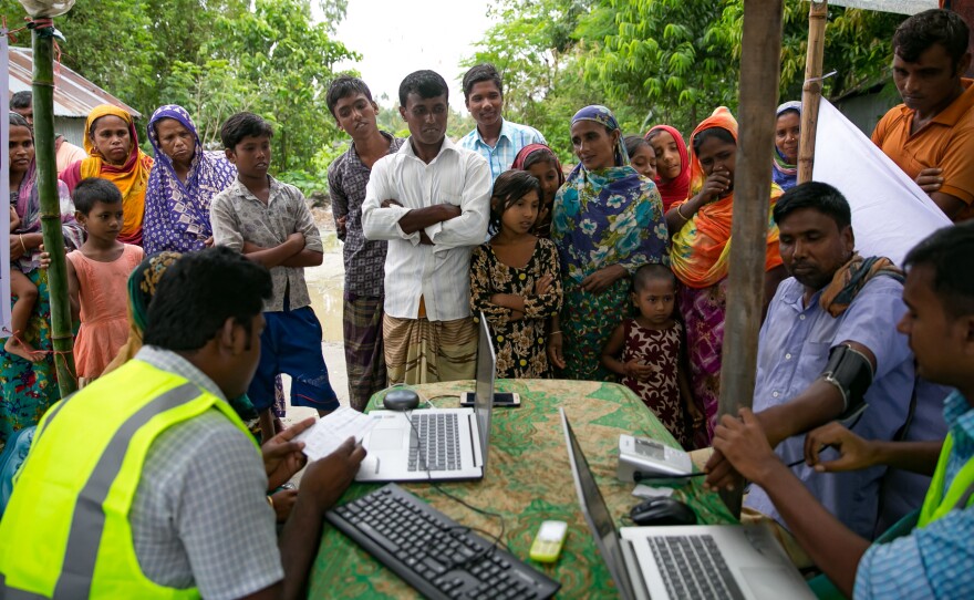 Patients line up for remote health consultation sessions on a remote island near Rangpur, Bangladesh.