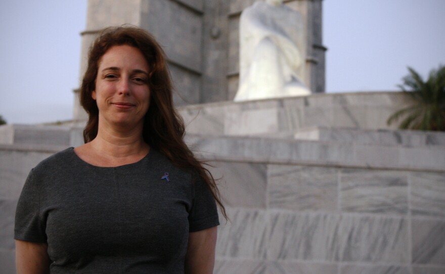 Cuban artist Tania Bruguera poses for a photograph near the statue of José Martí in Havana's Revolution Plaza. She was arrested in December for planning a political performance there.