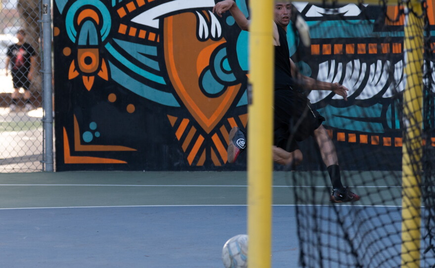 A futsal player looks on as the ball rolls toward the goal during a weekly pickup match in Barrio Logan on June 2, 2026, in San Diego, Calif.