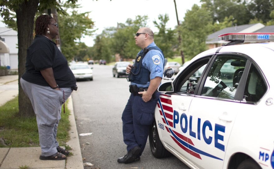 Earline Budd, a transgender advocate, speaks to a D.C. police officer about a spate of attacks in Washington, D.C.