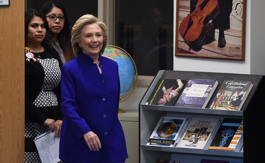 Astrid Silva (left) and Erika Castro with Clinton at Rancho High School in Las Vegas.