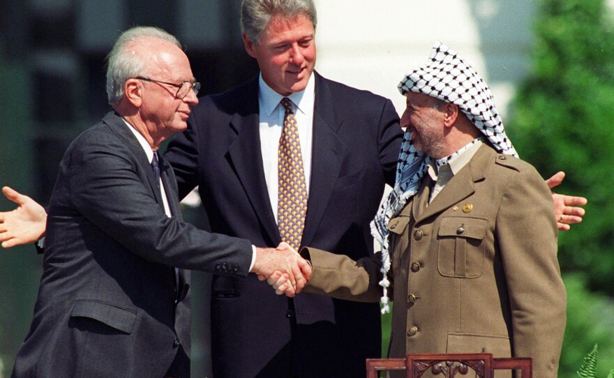 In this Sept. 13, 1993 file photo, President Clinton presides over White House ceremonies marking the signing of the peace accord between Israel and the Palestinians with Israeli Prime Minister Yitzhak Rabin, left, and Palestinian leader Yasser Arafat, right, in Washington.