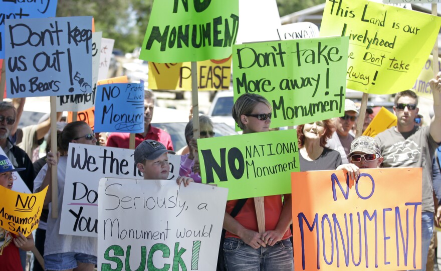 Last summer, protesters opposed to the creation of the Bears Ears monument held signs after U.S. Interior Secretary Sally Jewell arrived for a meeting with San Juan County Commissioners in Monticello, Utah. Now that the area has received monument designation, critics are calling on Donald Trump to undo it.