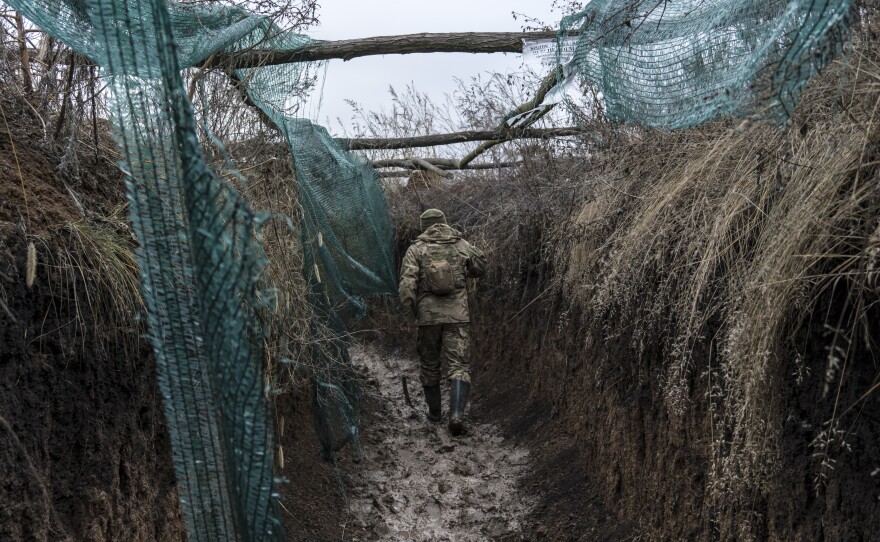 A Ukrainian soldier walks in a trench on the front line in Zolote, Ukraine, earlier this month. A buildup of Russian troops along the border with Ukraine has heightened worries that Russia intends to invade.