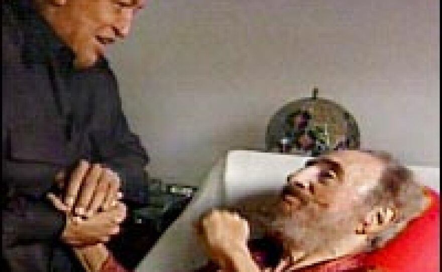 In a photo taken from Cuban television, Fidel Castro greets Venezuelan President Hugo Chavez -- seen by many as Castro's leftist successor in Latin America -- from his hospital bed. Castro is recovering from abdominal surgery and handed power over to his brother Raul.