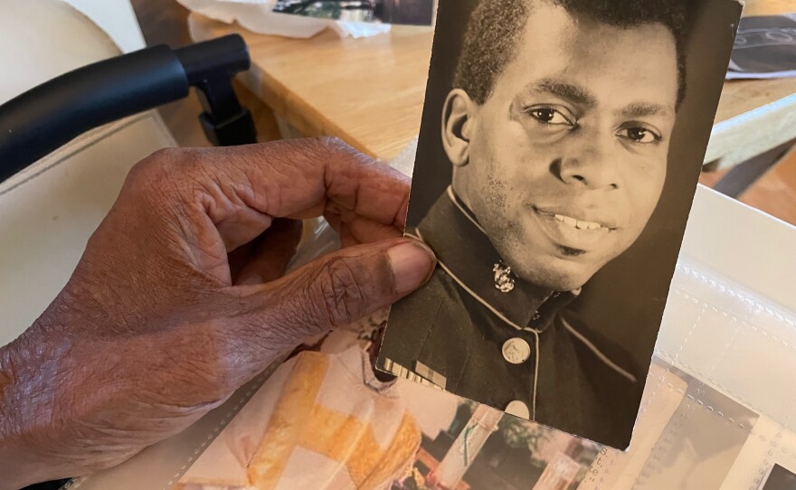 Robert Turner, Sr. holds a picture of himself as a young Marine.