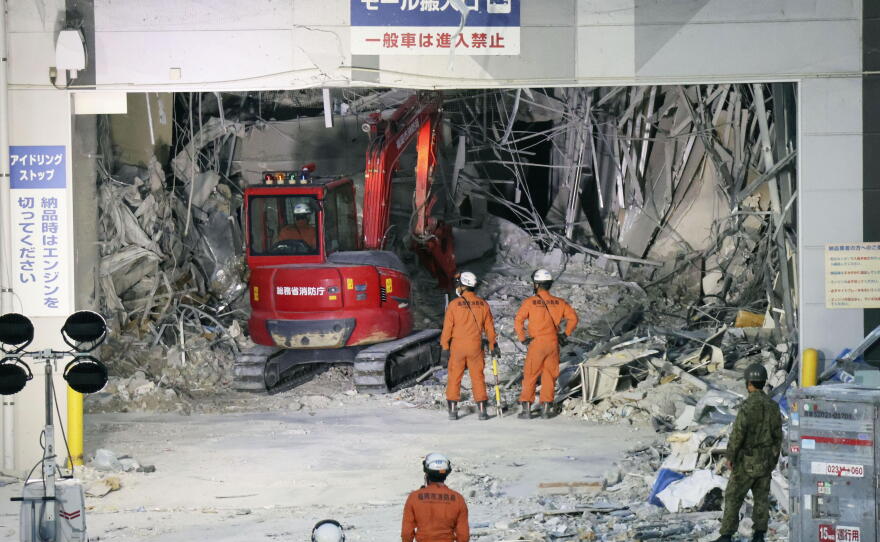Heavy machinery removes debris at AEON Mall, which was damaged by an explosion following an earthquake, in Kashima, Kumamoto Prefecture, southern Japan, Friday, July 31, 2026.
