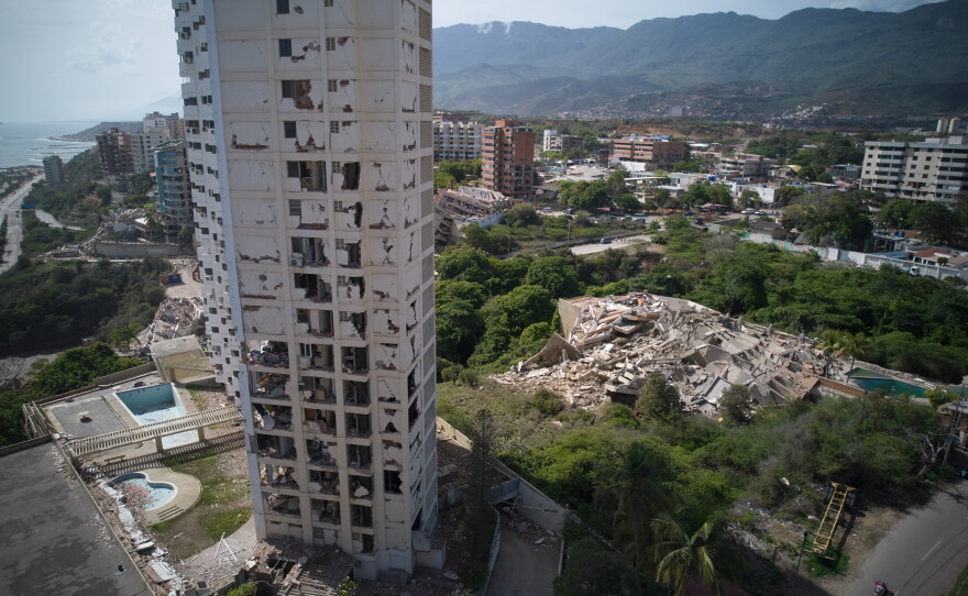 Damaged buildings stand a day after earthquakes struck La Guaira, Venezuela.