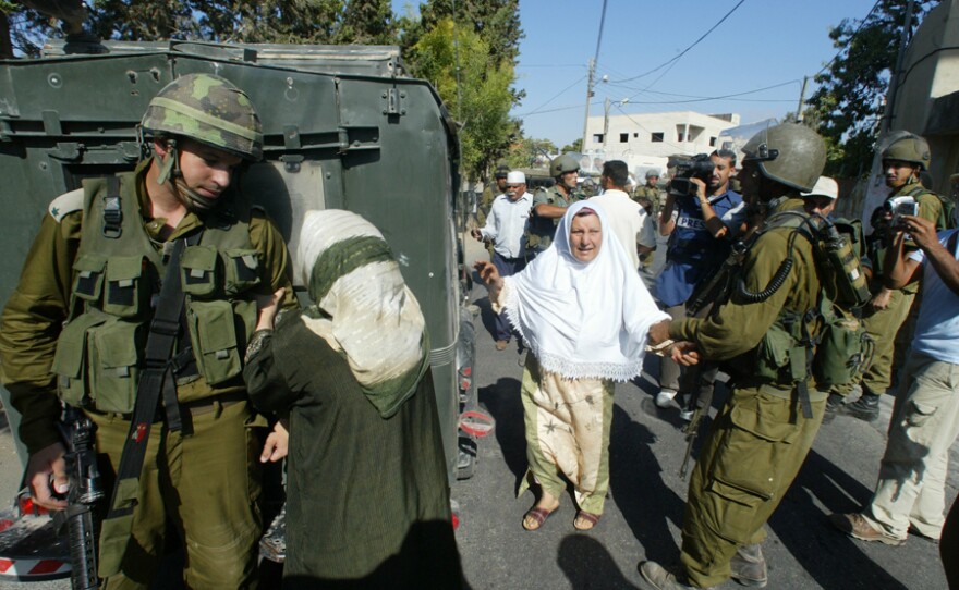 Emad's mother pleads with an Israeli soldier to release her son Khaled after he was arrested.