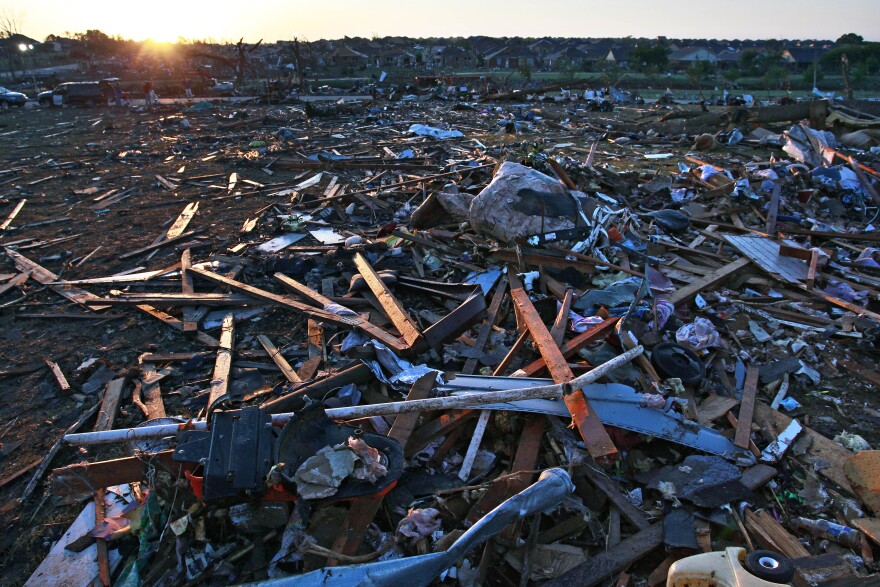 Debris litters a park adjacent to a neighborhood that was destroyed by a tornado in Moore, Okla., on Wednesday. The huge tornado roared through the Oklahoma City suburb, flattening a wide swath of homes and businesses.