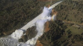 This aerial photo released by the California Department of Water Resources shows the damaged spillway with eroded hillside in Oroville, Calif., Feb. 11, 2017. 